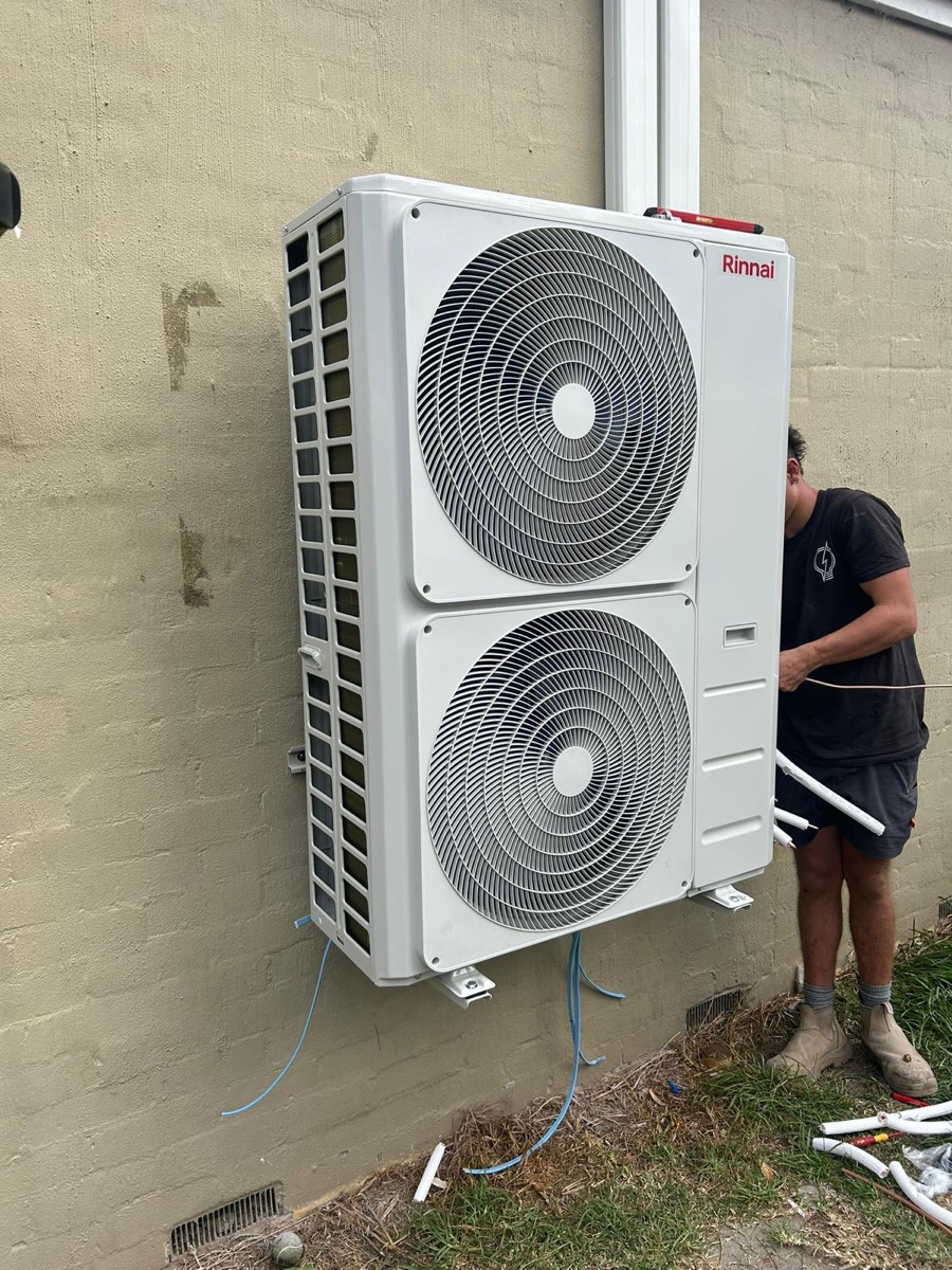 Large twin-fan outdoor unit during a ducted system installation