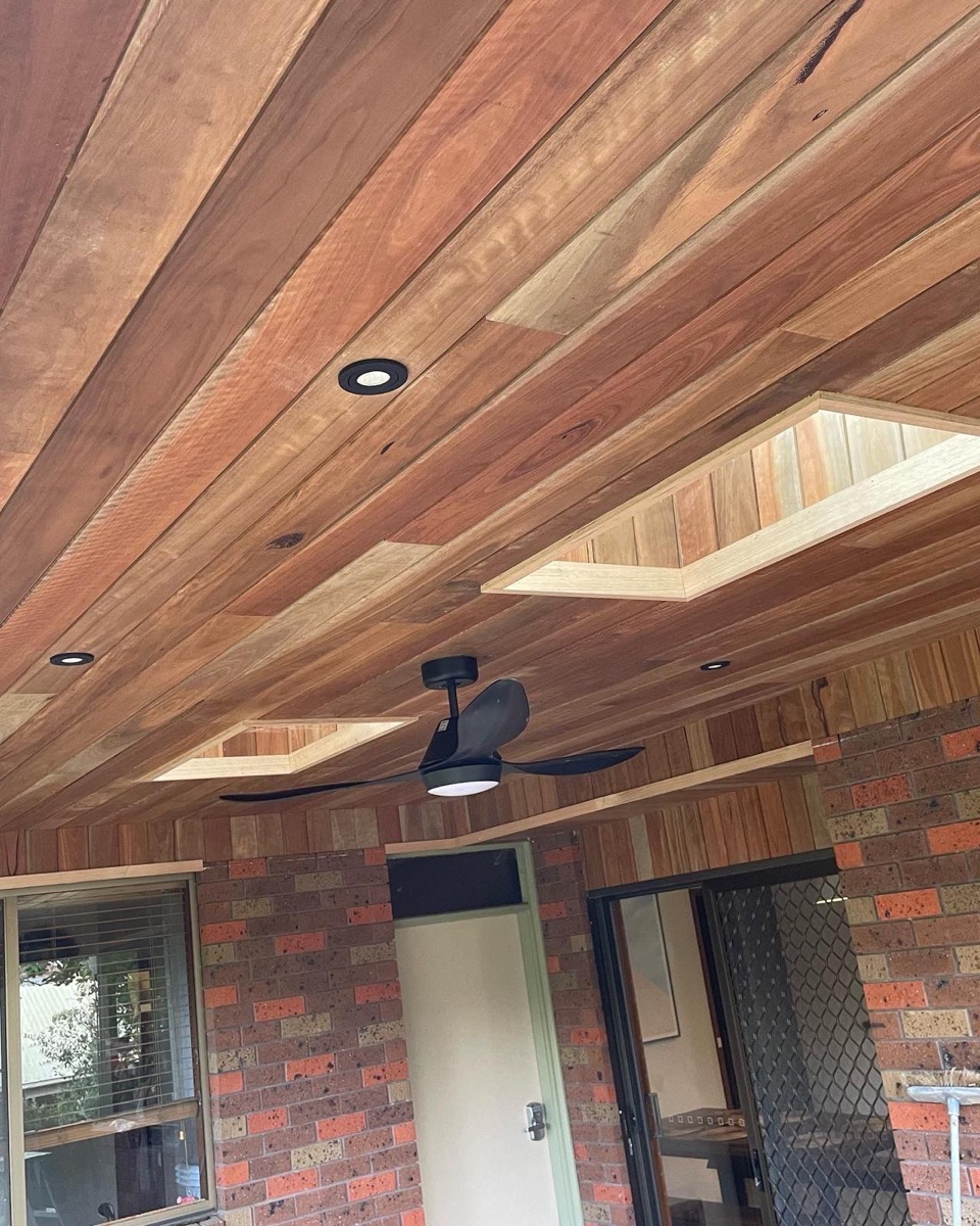 Recessed feature downlighting installed in a timber-lined alfresco ceiling by Hyper Electrical